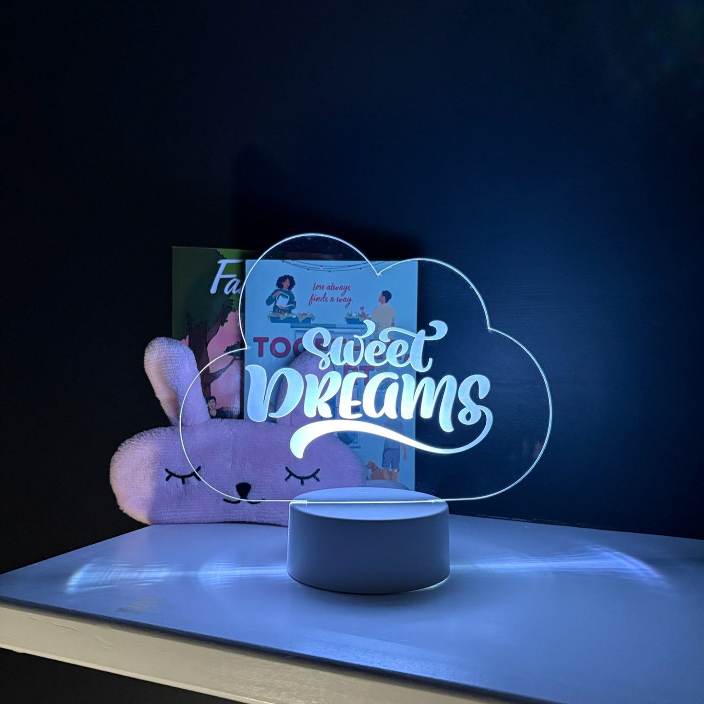 Decorative night light with 'Sweet Dreams' text on a dark background