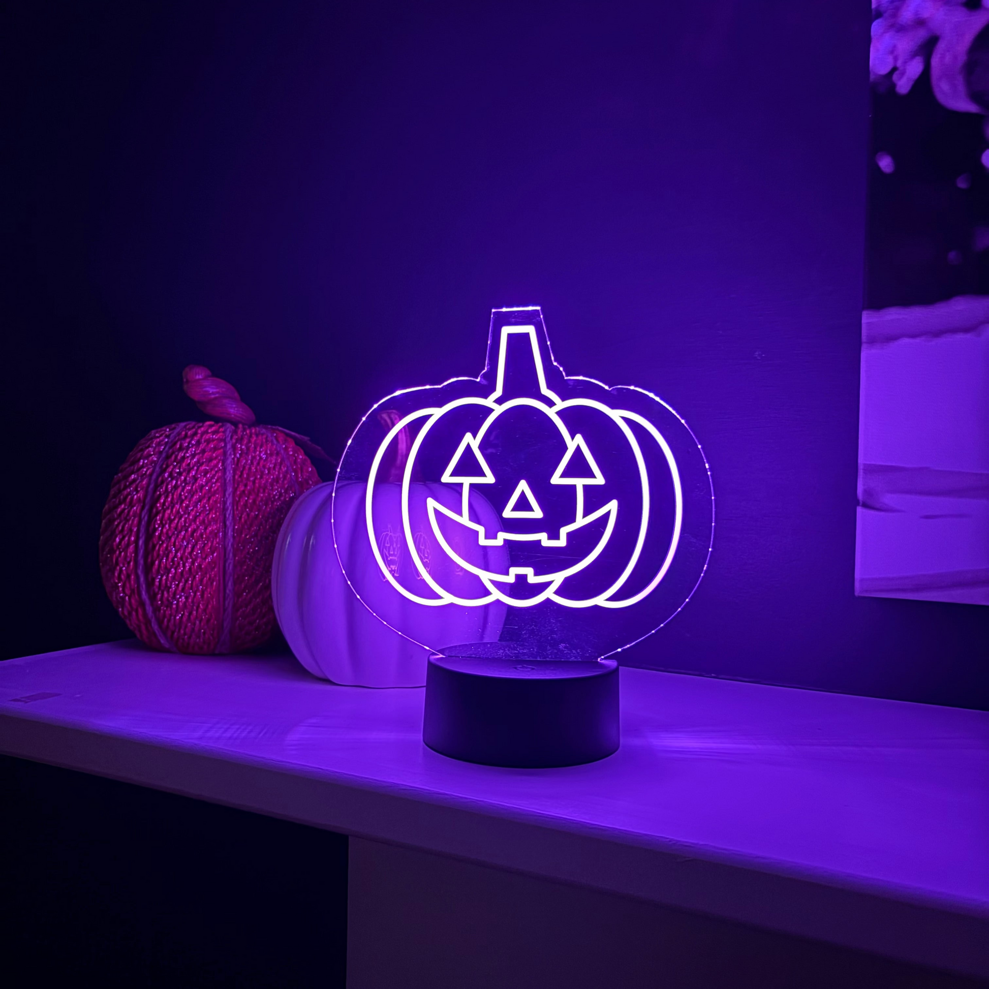 Halloween-themed LED lamp with jack-o'-lantern design on a purple background