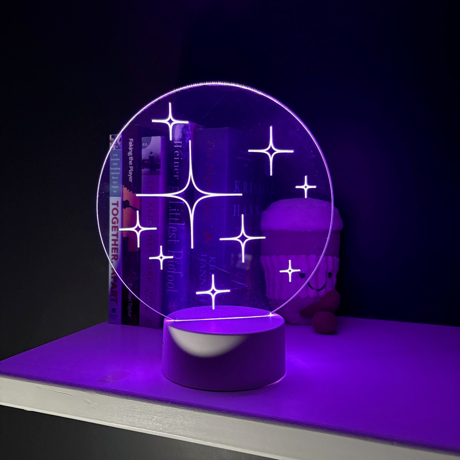Neon light fixture with geometric design on a dark background