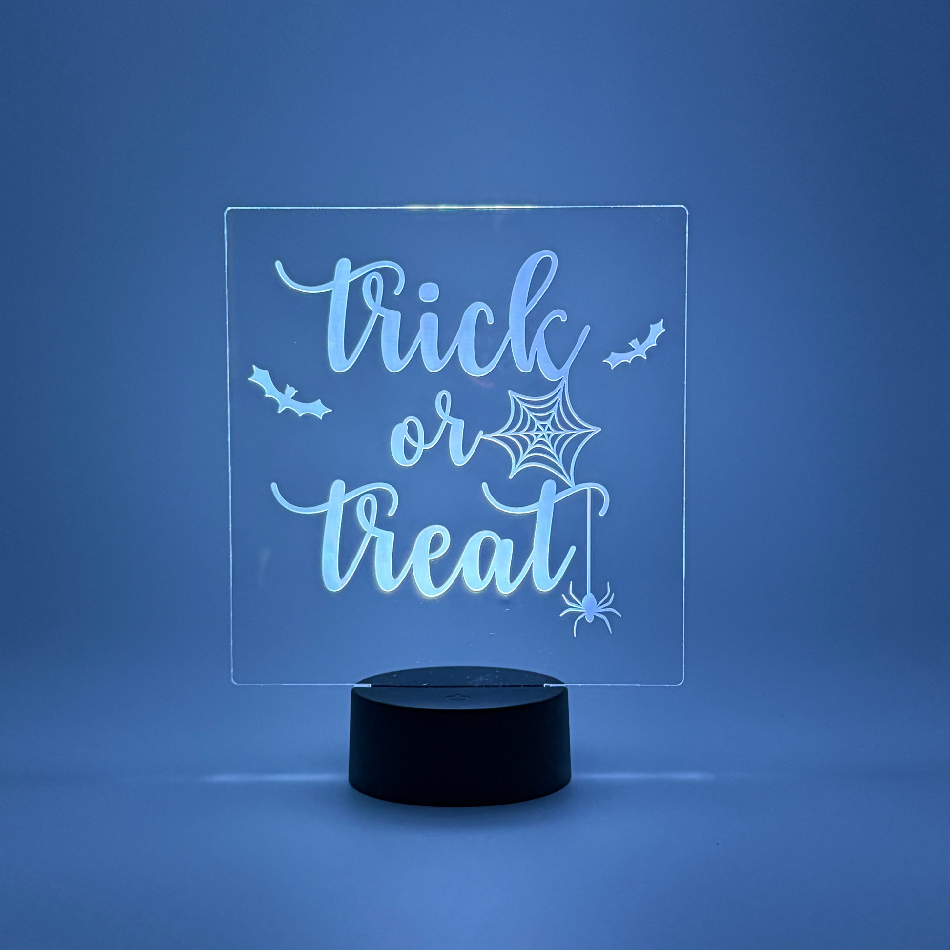 LED sign with 'trick or treat' text on a blue background