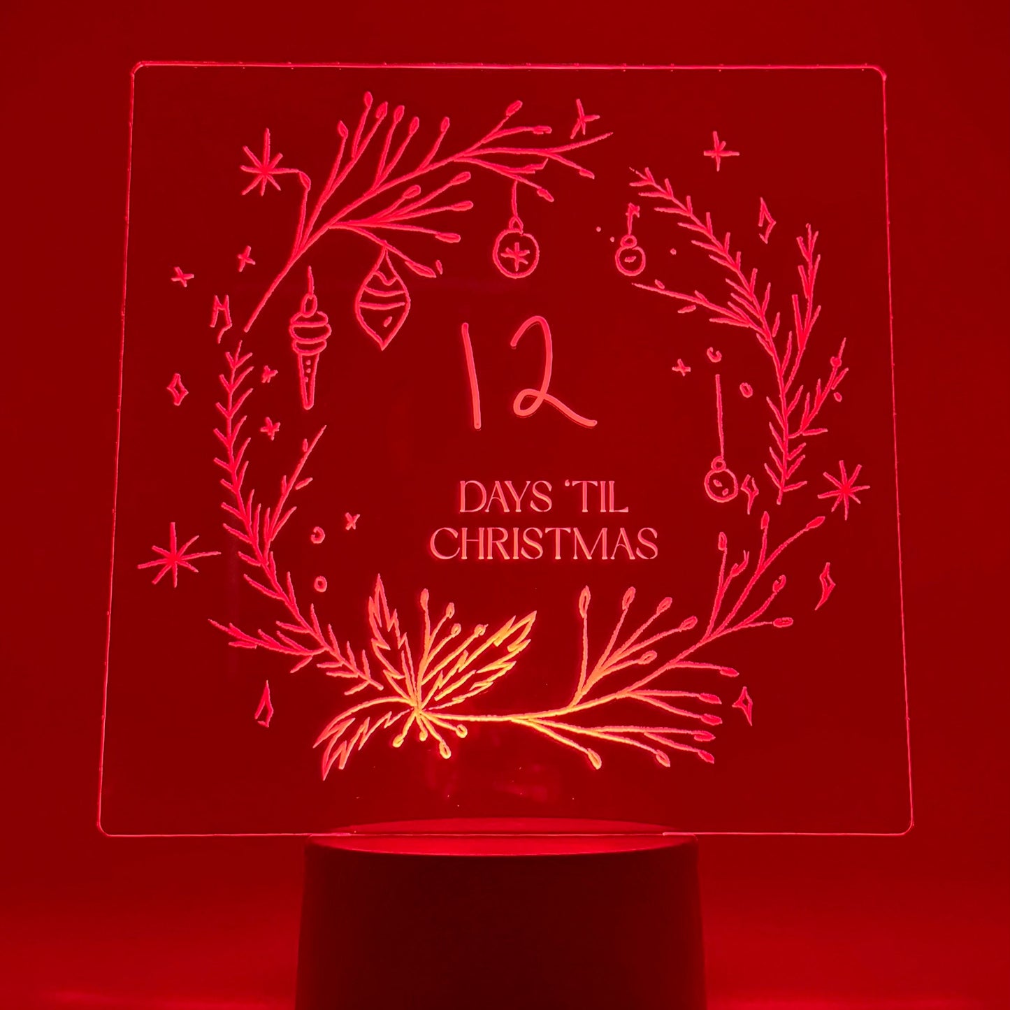 Decorative night light with '12 Days Til Christmas' design on a red background