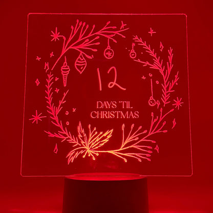 Decorative night light with '12 Days Til Christmas' design on a red background