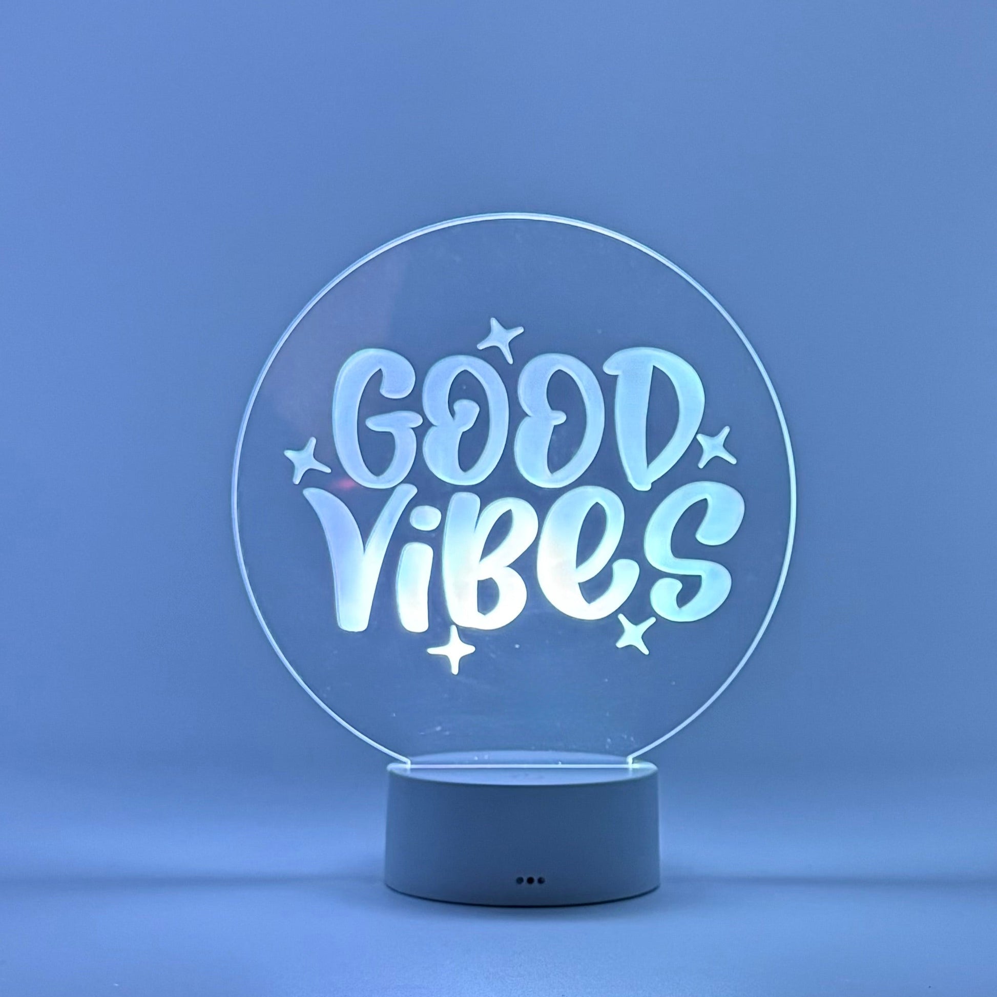 Decorative lamp with 'Good Vibes' text on a blue background