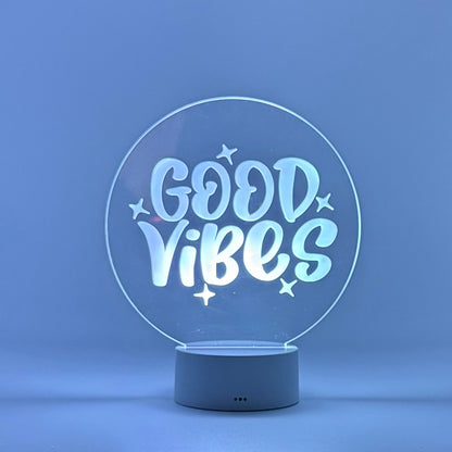 Decorative lamp with 'Good Vibes' text on a blue background
