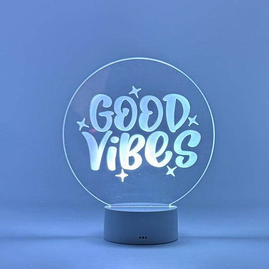 Decorative lamp with 'Good Vibes' text on a blue background